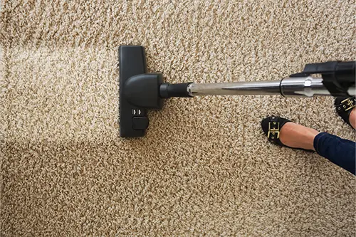 Sho-Me Clean Carpet Cleaning—A woman cleaning carpet with vacuum cleaner at a home in Branson, MO.