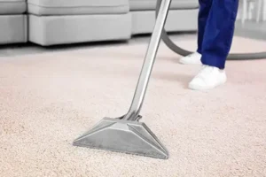 Sho-Me Clean Carpet Cleaning—A person in blue jeans and white sneakers vacuums a carpet in a home in Branson, MO.