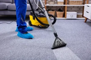 Sho-Me Clean Carpet Cleaning—A professional cleaner using a vacuum cleaner to clean a carpet in a Branson, MO home.