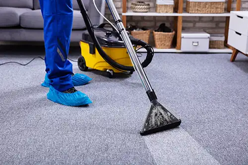 Sho-Me Clean Carpet Cleaning—A professional cleaner using a vacuum cleaner to clean a carpet in a Branson, MO home.